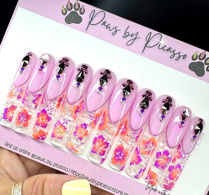 Set of pink nail wraps with floral designs on a 'Paws by Picasso' branded card.