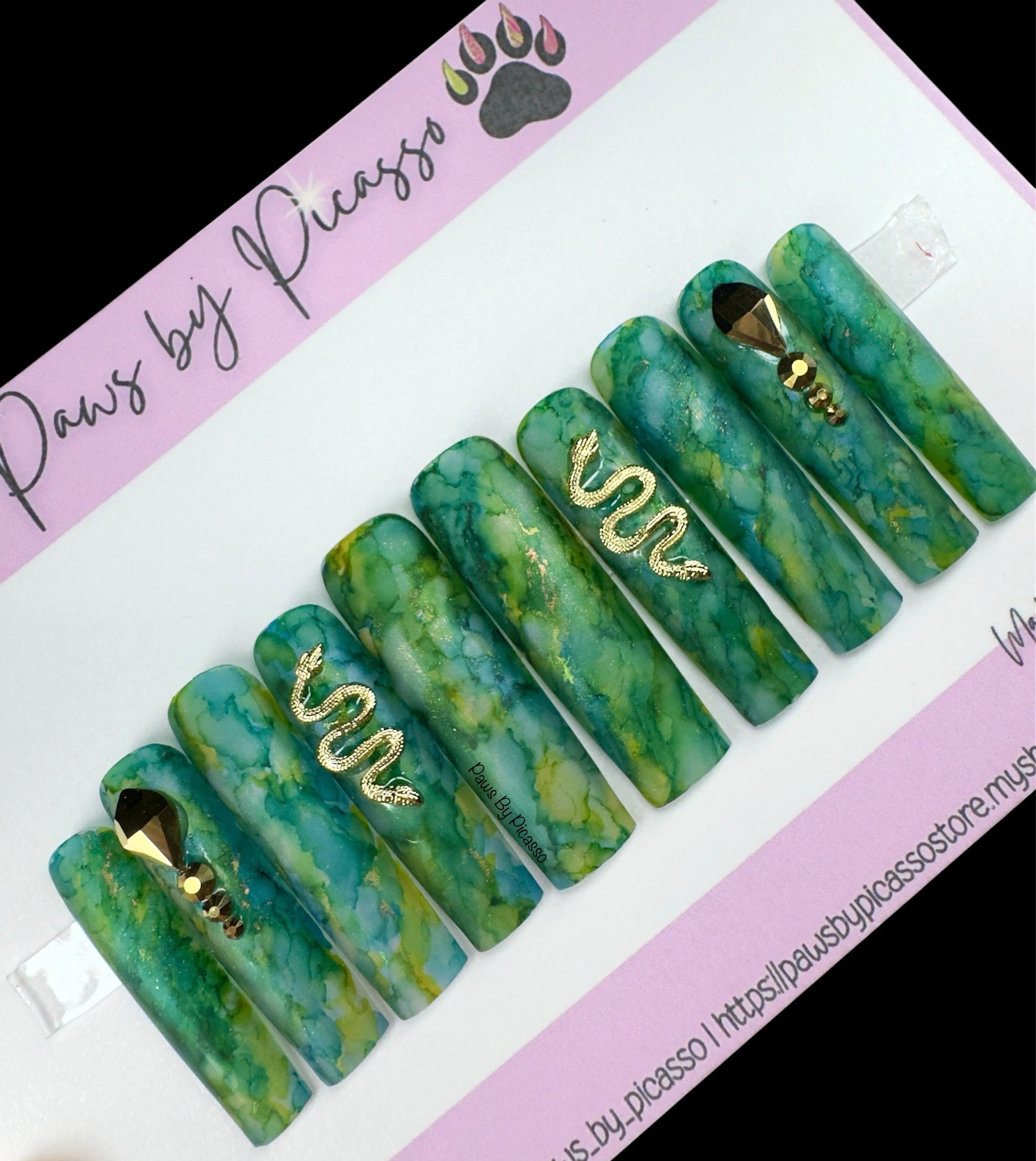 Set of green marbled dog nails with gold accents on a Paws by Picasso branded card.