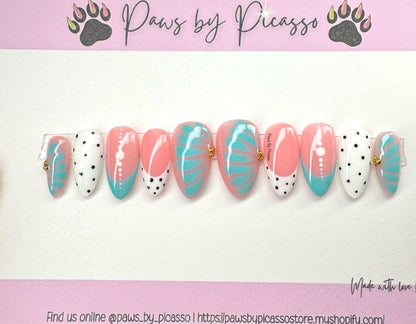 Nail art designs with pink and turquoise patterns on a white background, branded 'Paws by Picasso'.